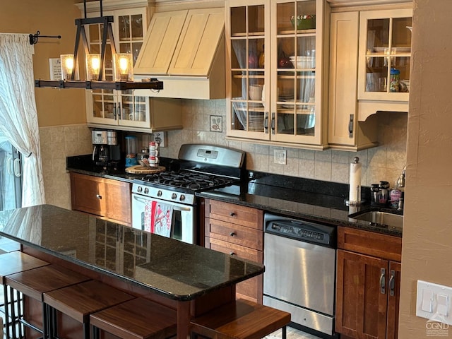 kitchen featuring a breakfast bar, decorative light fixtures, custom exhaust hood, appliances with stainless steel finishes, and glass insert cabinets