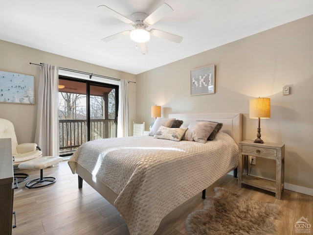 bedroom featuring baseboards, ceiling fan, wood finished floors, and access to exterior