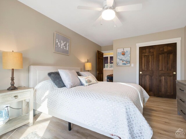 bedroom with light wood-type flooring and ceiling fan