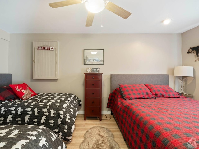 bedroom featuring light wood finished floors and a ceiling fan