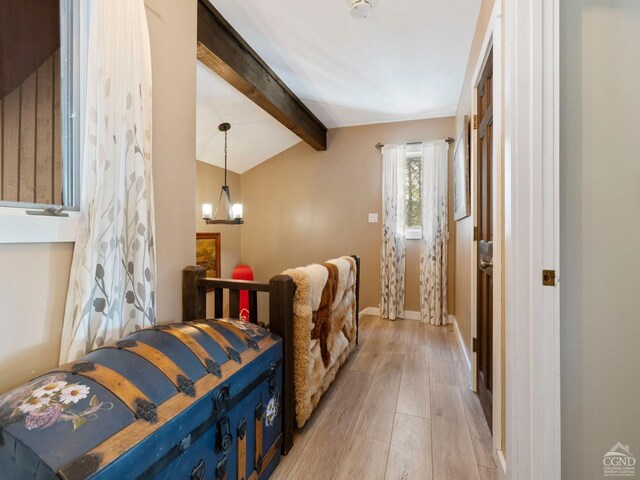 kitchen featuring a fireplace, beamed ceiling, an AC wall unit, dark stone countertops, and light tile patterned flooring