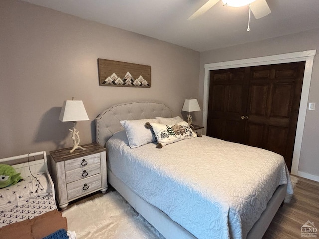 bedroom featuring ceiling fan, baseboards, a closet, and wood finished floors