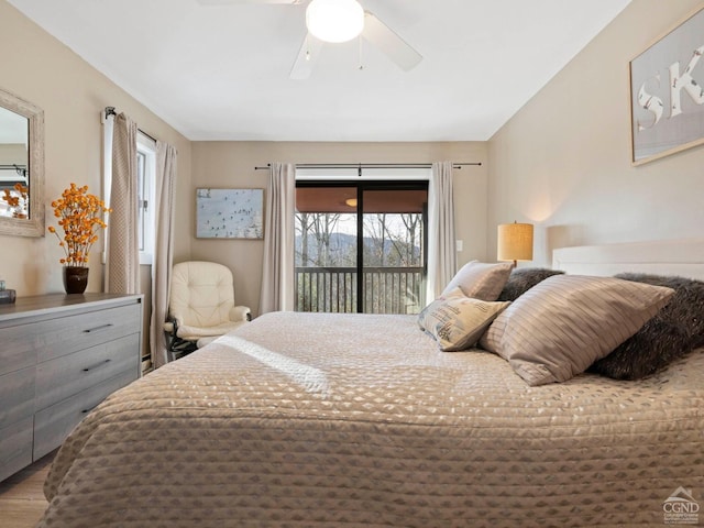 bedroom featuring a ceiling fan, access to outside, and wood finished floors