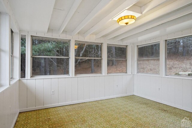 unfurnished sunroom with beam ceiling