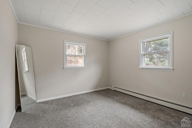 carpeted spare room with a baseboard radiator and ornamental molding