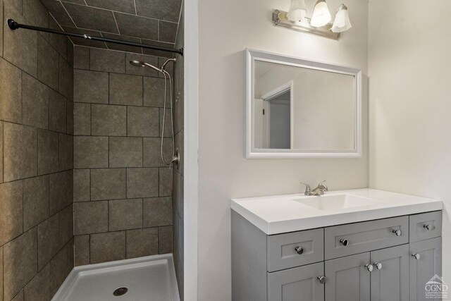 bathroom with vanity and tiled shower