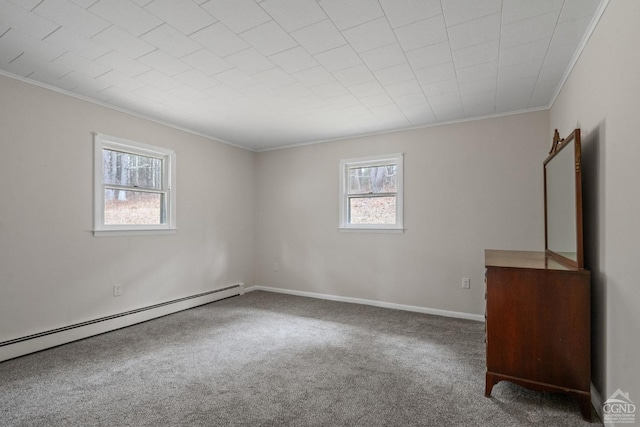 spare room featuring crown molding, plenty of natural light, carpet, and a baseboard radiator