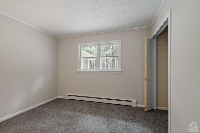 unfurnished bedroom with crown molding, a closet, carpet, and a baseboard radiator