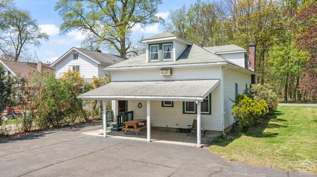 view of front of property with a front lawn, roof with shingles, and a chimney