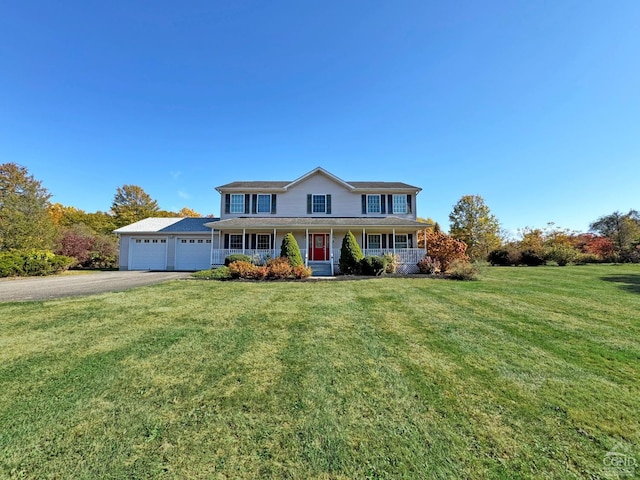 view of front facade featuring a porch, a garage, and a front lawn