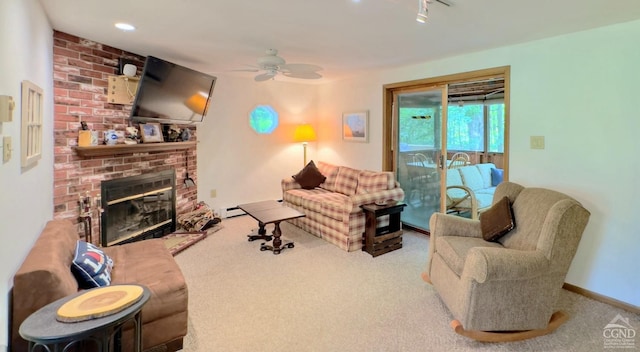 carpeted living room featuring a fireplace and ceiling fan