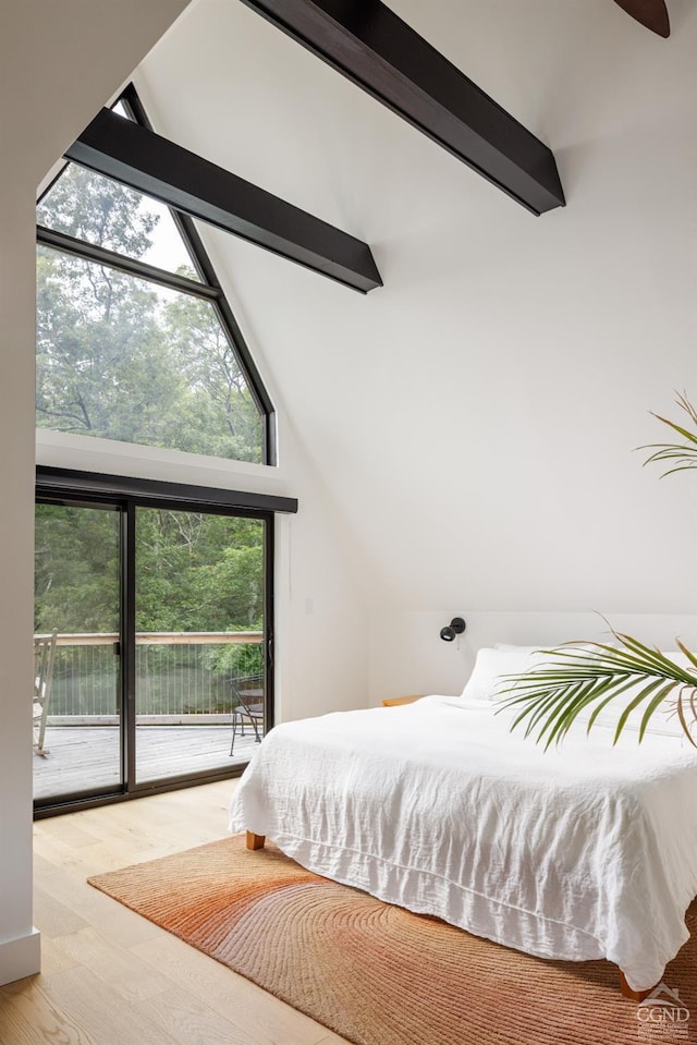 bedroom featuring high vaulted ceiling, light wood-type flooring, access to outside, and multiple windows