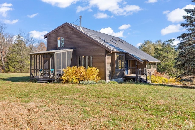 view of side of home featuring a lawn and a sunroom