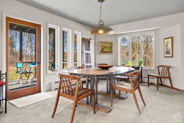 carpeted dining area featuring a baseboard radiator