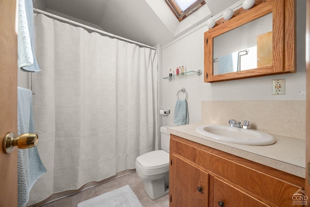 bathroom with toilet, vanity, lofted ceiling with skylight, and tile patterned flooring