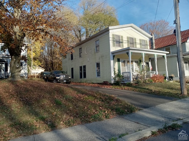 view of side of home featuring a porch