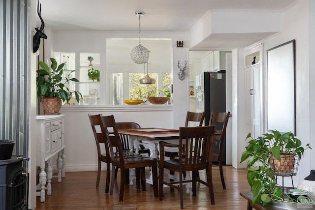 dining space featuring baseboards and wood finished floors
