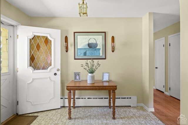 entryway featuring light wood-type flooring and a baseboard heating unit