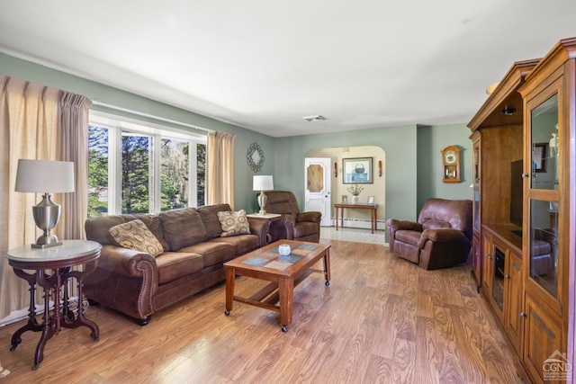 living room with light wood-type flooring and baseboard heating