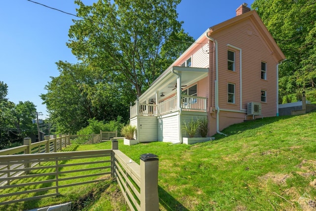 view of side of home with a lawn