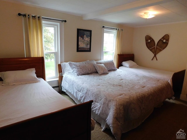 bedroom featuring beam ceiling and a baseboard heating unit