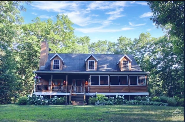 view of front of home with a porch, a front yard, a sunroom, and a chimney