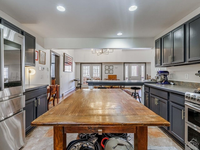 kitchen featuring appliances with stainless steel finishes, recessed lighting, french doors, and a peninsula