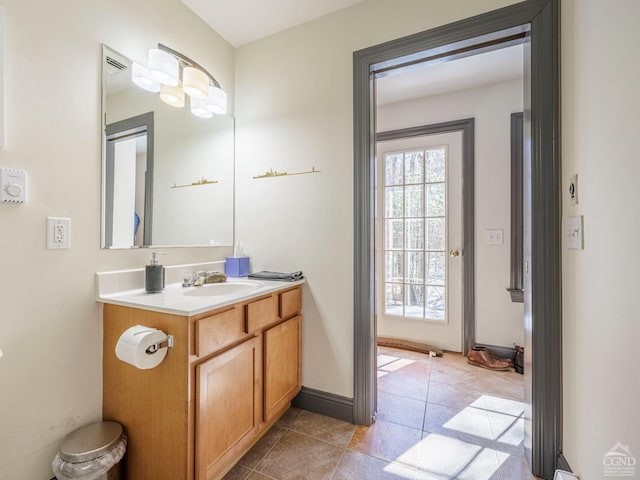 bathroom with tile patterned floors, baseboards, and vanity