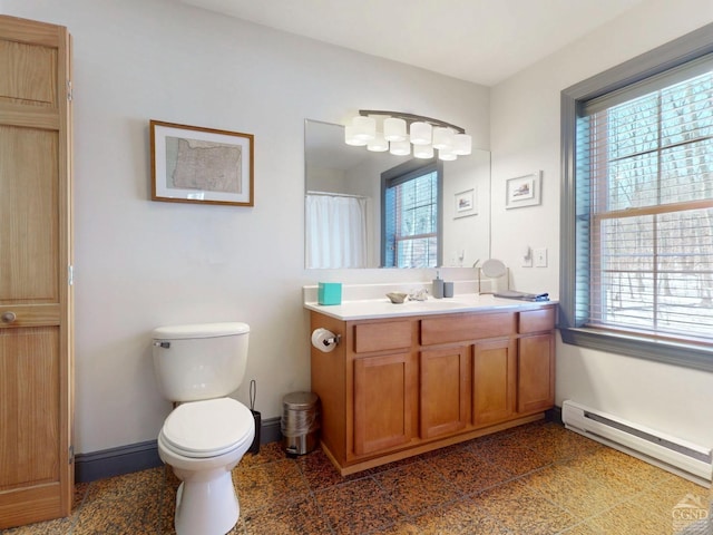 bathroom featuring a wealth of natural light, a baseboard radiator, granite finish floor, and baseboards