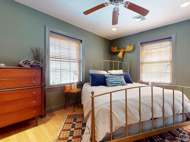 bedroom with recessed lighting, wood finished floors, visible vents, baseboards, and a ceiling fan