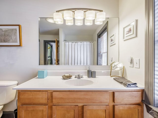 bathroom with toilet, curtained shower, and vanity