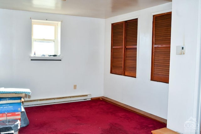 carpeted spare room with a baseboard radiator