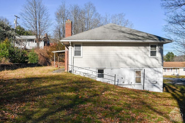 view of side of property with a lawn