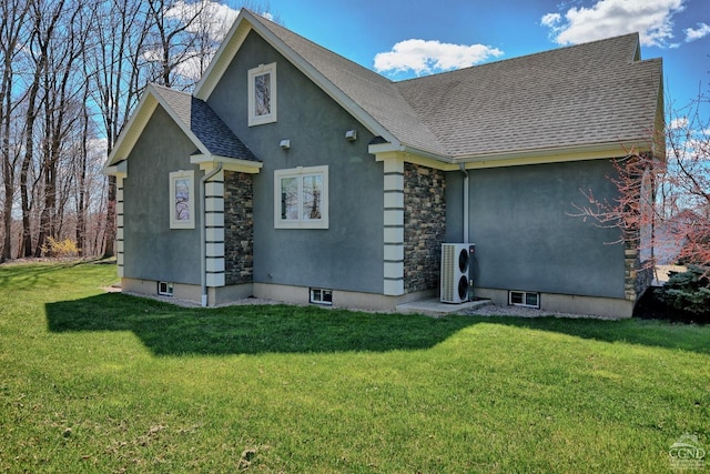 view of front of home with ac unit and a front yard