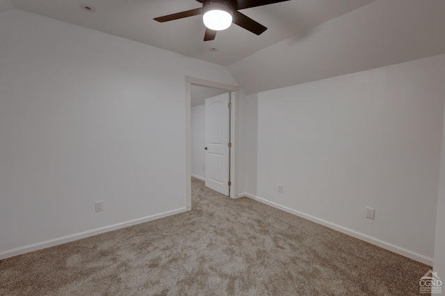 carpeted empty room featuring ceiling fan and lofted ceiling