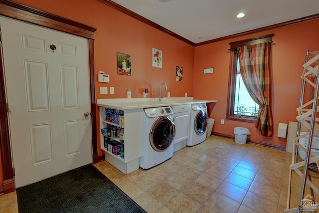 clothes washing area with light tile patterned flooring, sink, separate washer and dryer, and crown molding