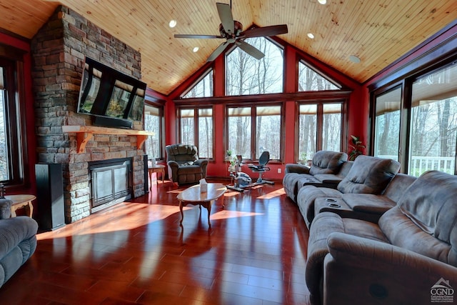 living room featuring hardwood / wood-style floors, a fireplace, high vaulted ceiling, and wood ceiling