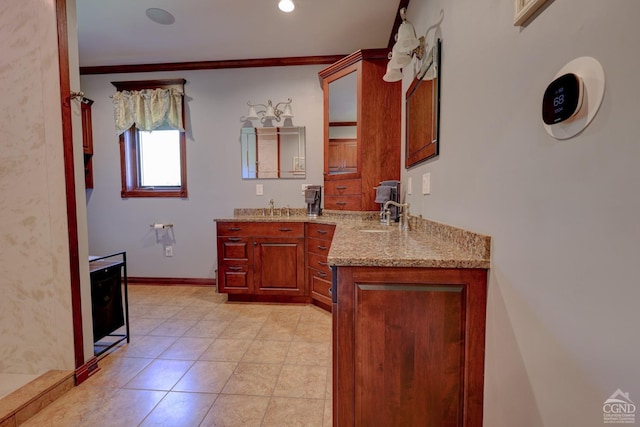 bathroom featuring tile patterned floors, crown molding, and vanity