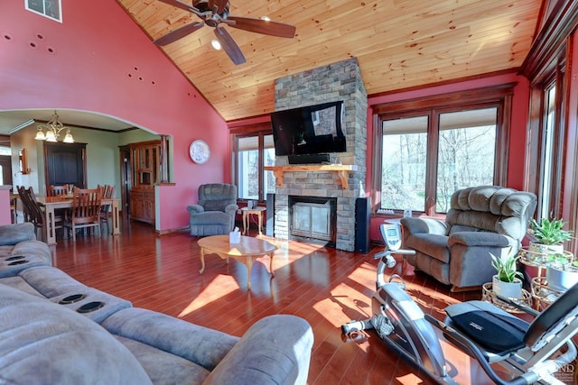 living room with ceiling fan with notable chandelier, hardwood / wood-style flooring, high vaulted ceiling, and a wealth of natural light