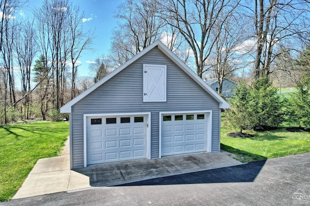 garage featuring a lawn