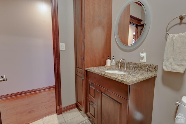 bathroom with hardwood / wood-style floors, vanity, and toilet