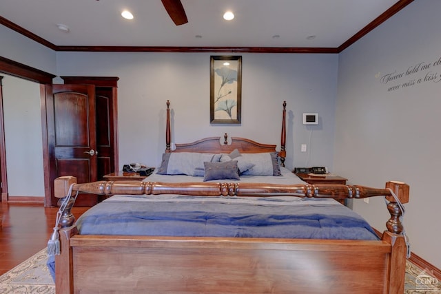 bedroom featuring hardwood / wood-style flooring, ceiling fan, and crown molding