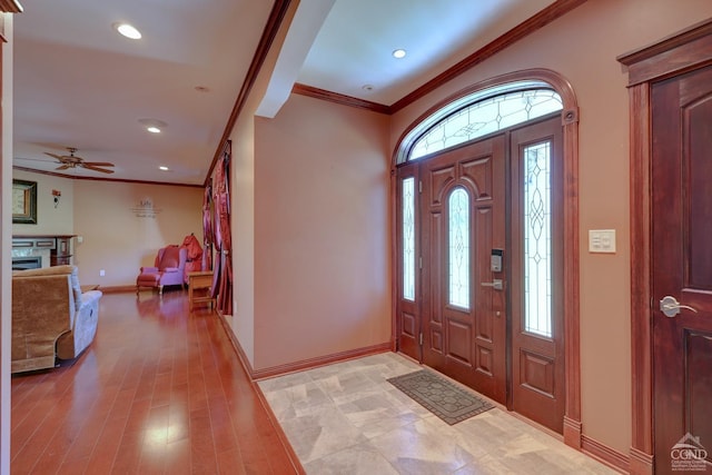 entryway featuring plenty of natural light, light hardwood / wood-style floors, and crown molding