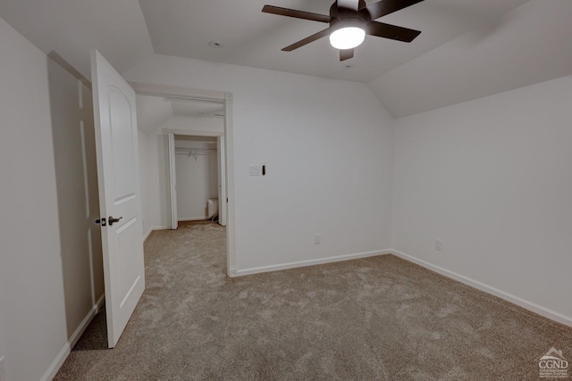 unfurnished room with light colored carpet, ceiling fan, and lofted ceiling