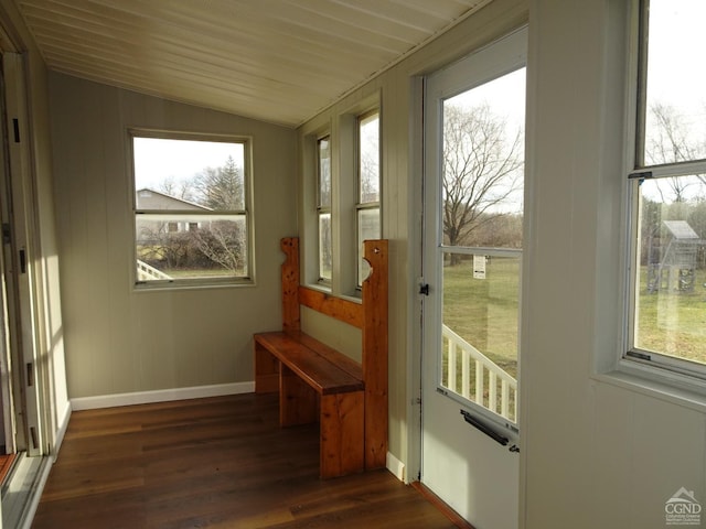 unfurnished sunroom featuring lofted ceiling and a healthy amount of sunlight