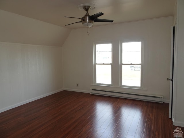 additional living space with vaulted ceiling, ceiling fan, dark hardwood / wood-style floors, and a baseboard heating unit