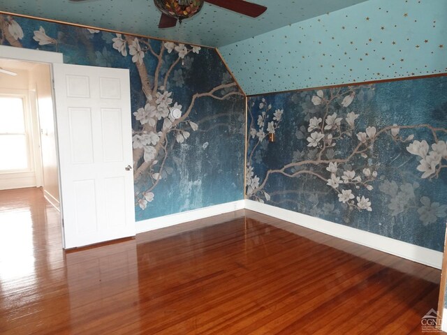 spare room featuring ceiling fan, lofted ceiling, and hardwood / wood-style flooring