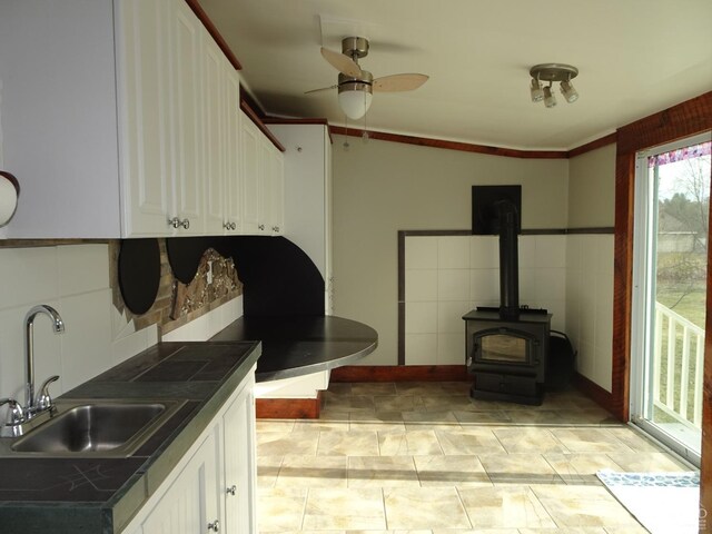 kitchen featuring white cabinets, ceiling fan, lofted ceiling, and sink