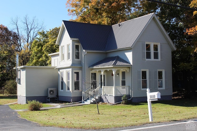 view of front facade featuring covered porch and a front yard