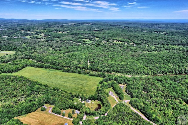 birds eye view of property featuring a view of trees